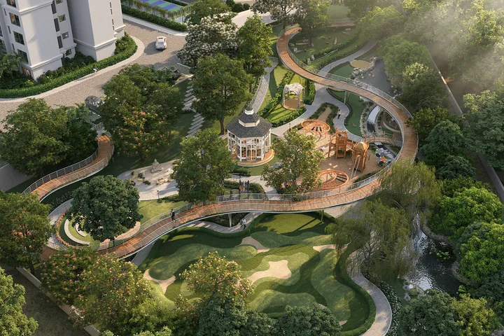 An aerial view of a winding forest trail and gazebo